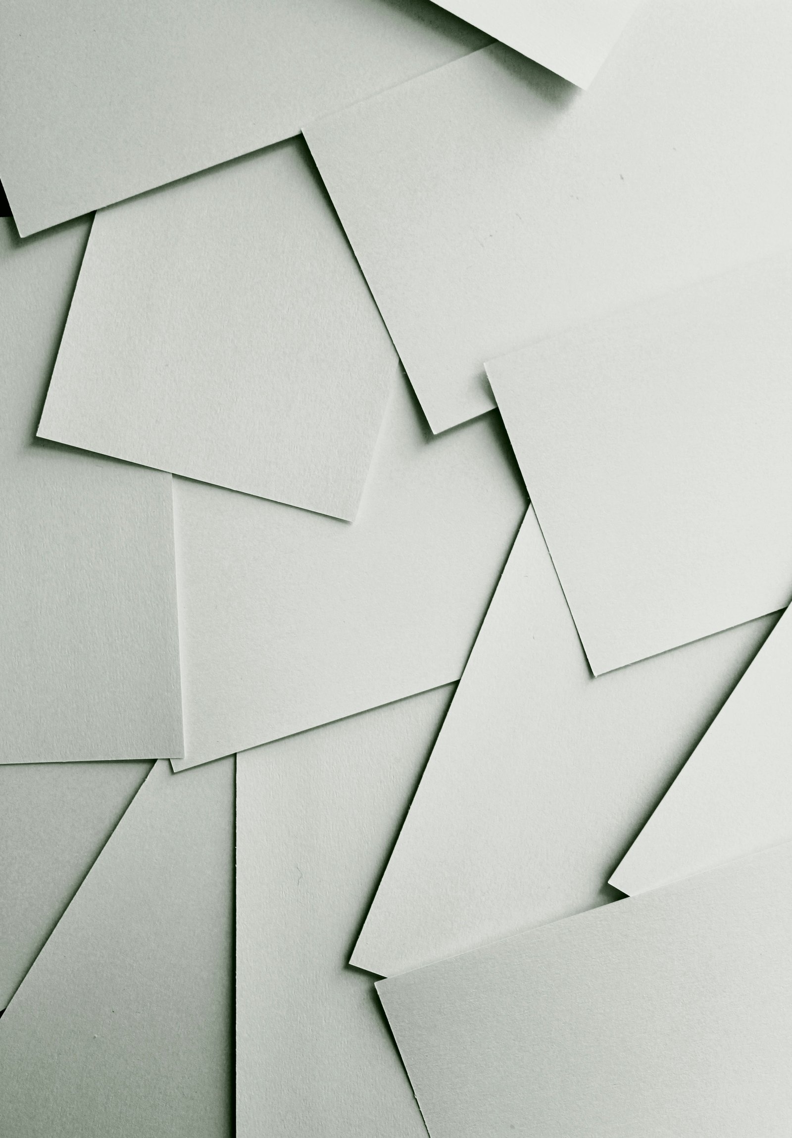 Layered papers representing employment records and compliance documents